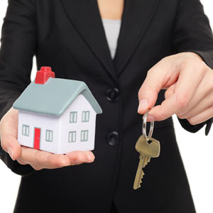 Woman handing over keys to new house