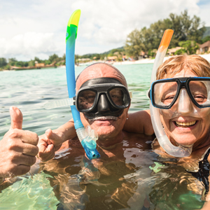 Older couple snorkeling on vacation