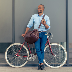 Man riding bike to work to save money