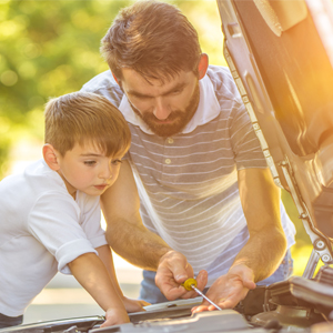 Father and son working on car