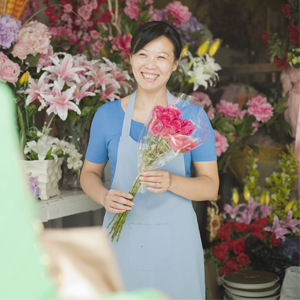 Florist handing customer bouquet