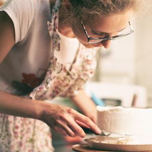 Female baker icing cake
